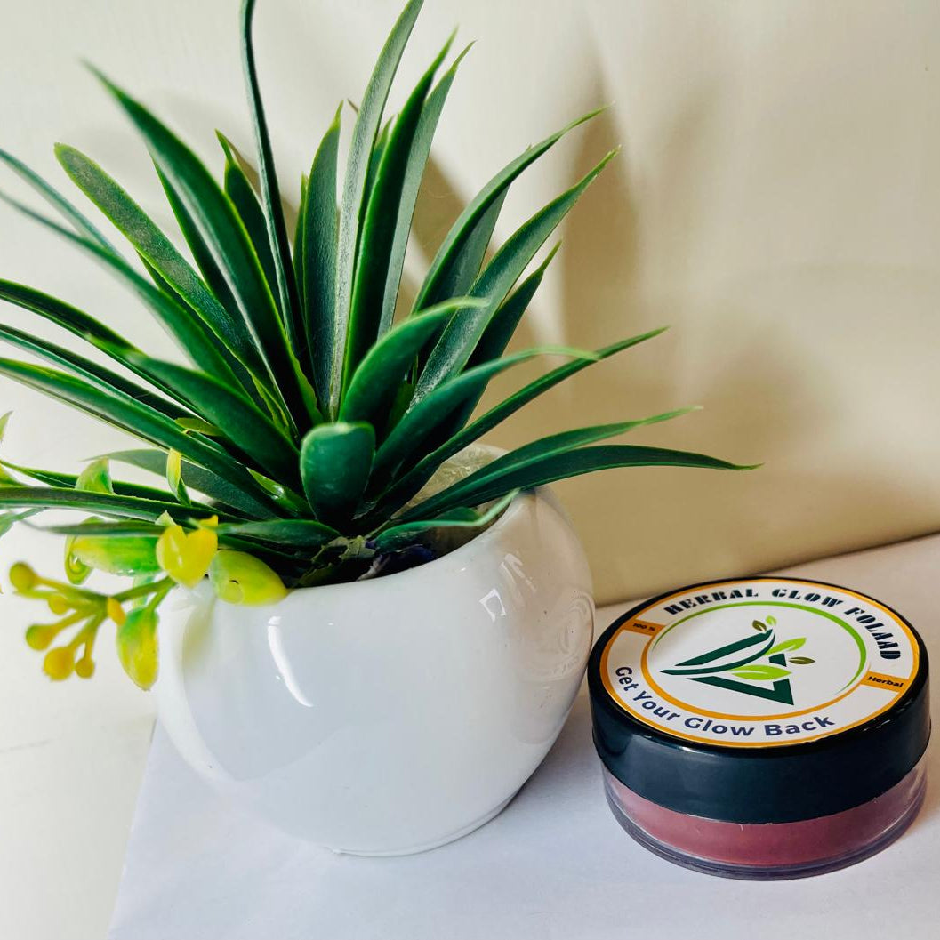Potted plant next to a jar labeled 'Kneal Glow' on a light background